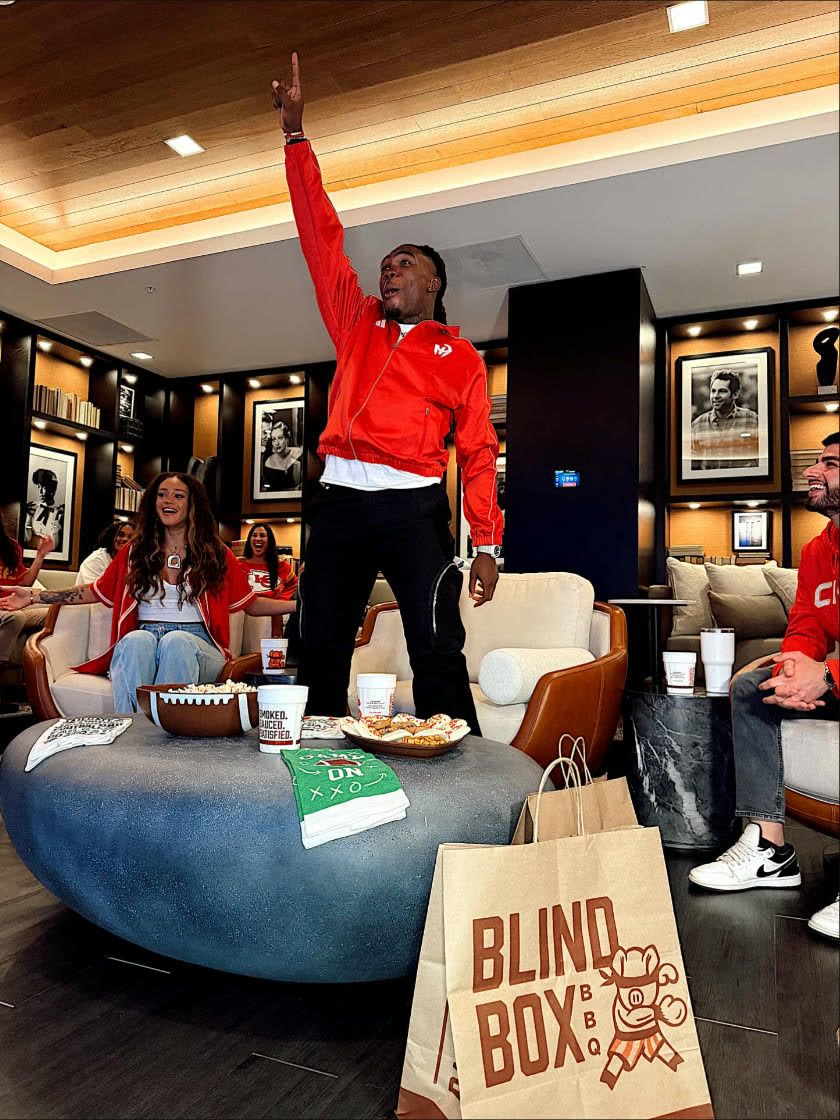 Rashee Rice celebrating at a Blind Box BBQ watch party