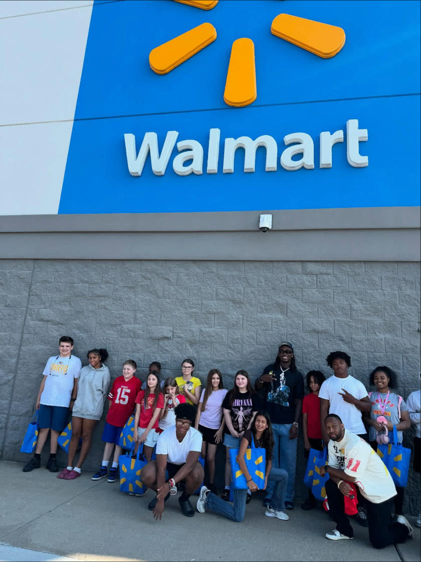 Rashee Rice with a group of kids outside Walmart for a back-to-school event
