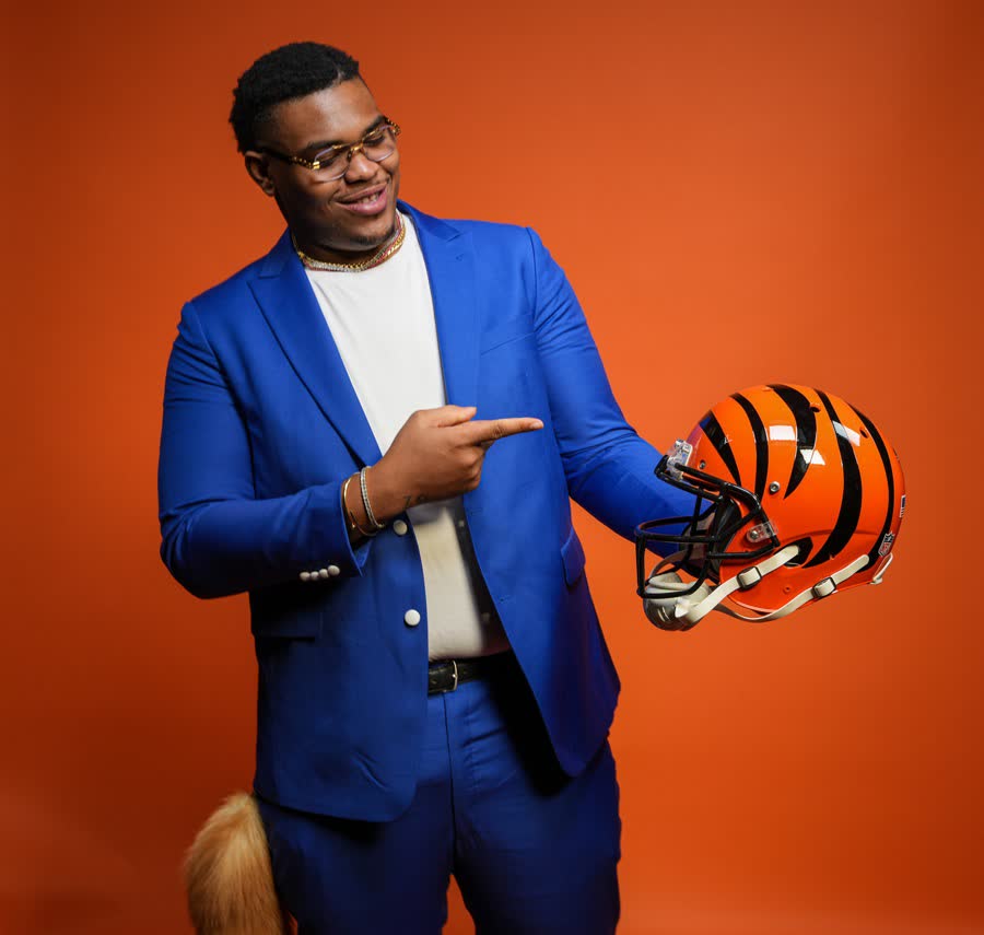 Client holding a Bengals helmet at a brand shoot