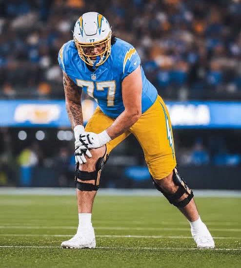 Travis Burke in a Los Angeles Chargers uniform, number 77